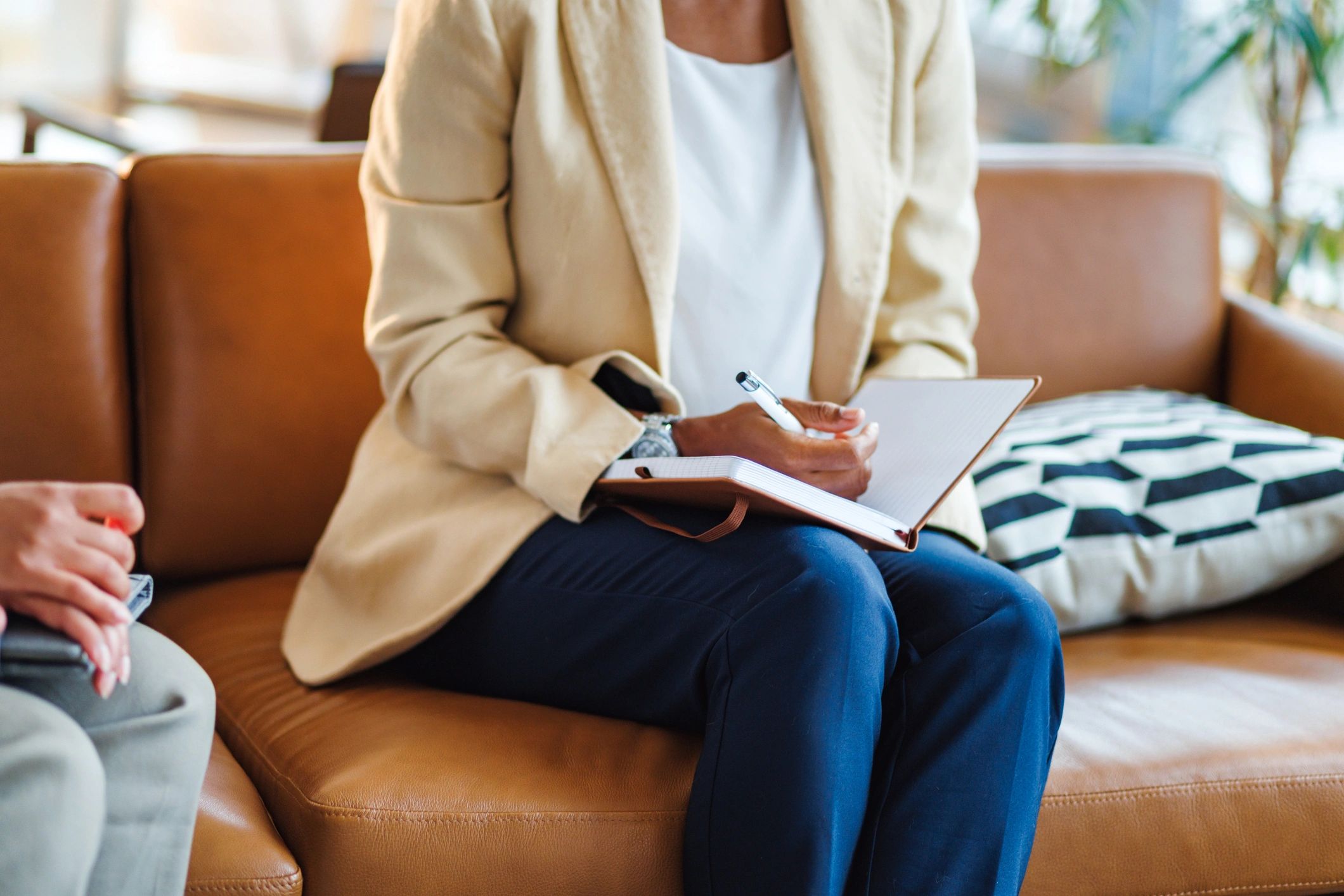 Person taking notes during a coaching conversation
